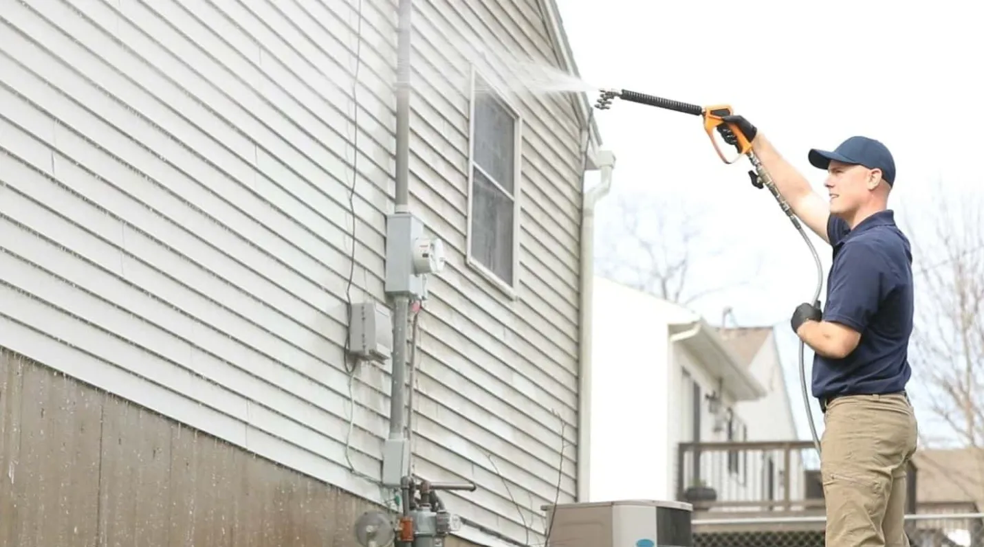 Property Power Wash technician soft-washing home siding
